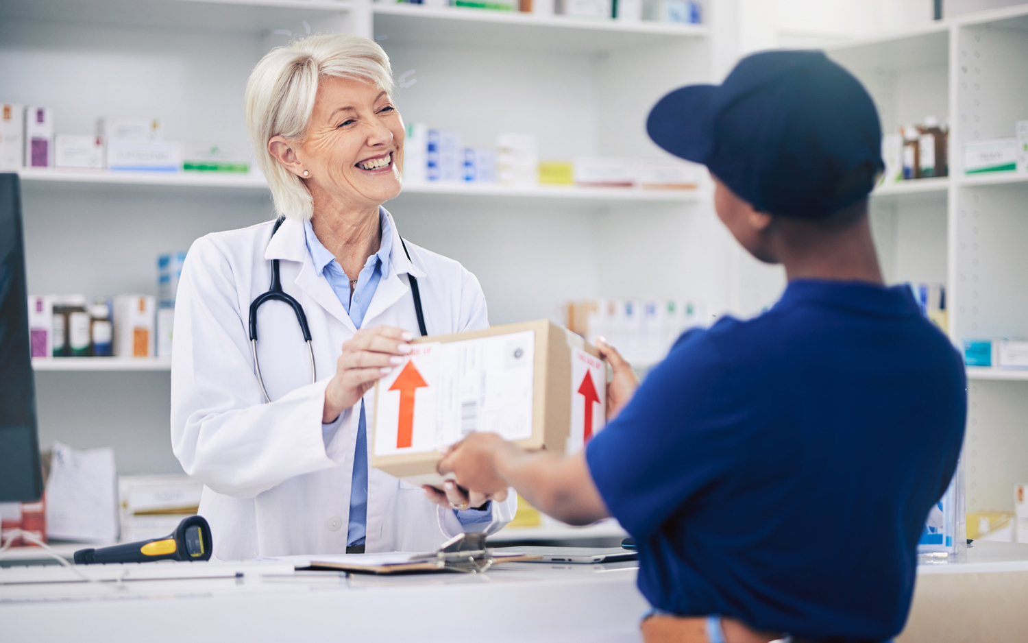 Pharmacist, package and delivery with woman in drug store for medical supplies with courier service